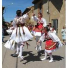 Cuatro danzantes de la Virgen ejecutan uno de los pasos del paloteo