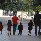 Una padres llevan a sus hijos al colegio en León.