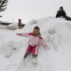 Varios niños se deslizan sobre la nieve en Puebla de Lillo.