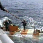 Miembros de los equipos de rescate rusos regresan en un minisubmarino tras una inmersión en busca del sumergible siniestrado en el mar de Barents.