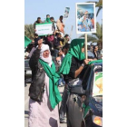 Adeptos al Gobierno libio sostienen fotografías de su líder.