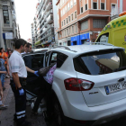 La tía del menor trata de que éste baje del coche ante la mirada de un técnico de ambulancia.