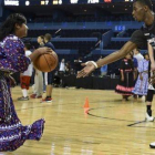 Una jugadora mexicana ataviada con un traje típico, con un jugador del Minnesota.