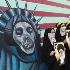Estudiantes iranís sostienen fotos del ayatolá Jamenei ante el muro de la antigua Embajada de EEUU en Teherán, el viernes, durante los actos de celebración de la toma de la legación estadounidense, hace 32 años.
