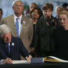 Bill Clinton, expresidente de EEUU, firma en el libro de condolencias ante la mirada de Madeleine Albright, exsecretaria de Estado de Estados Unidos.