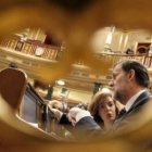 Sáenz de Santamaría y Rajoy conversan sentados en sus escaños en el Congreso de los Diputados.