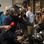 Yanis Varoufakis, rodeado de cámaras al abandonar ayer su oficina.