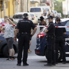EFE / JOSÉ MANUEL VIDAL  Agentes de policía y vecinos, frente al domicilio donde un hombre ha matado a su expareja, en Sevilla.
