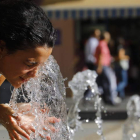 Une mujer se refresca en Córdoba en plena ola de calor en agosto de este año. SALAS