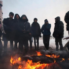 Un grupo de refugiados se protege del frio en Bergrado, Serbia.