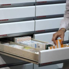 Una farmacéutica guarda medicamentos.