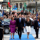 La reina y los príncipes de Asturias a su llegada al Teatro Campoamor de Oviedo. Tras ellos, la protesta por los recortes.