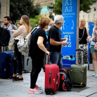 Turistas esperando el Aerobus en la Plaza Cataluña.