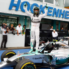 Rosberg sobre su bólido con gesto victorioso.
