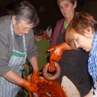 Unas mujeres preparan los chorizos que más tarde iban a ser degustados.
