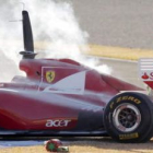 El brasileño de Ferrari, Felipe Massa, contempla su coche tras incendiarse el motor.