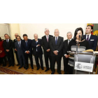 Diferentes personalidades de las que acudieron al acto observan cómo la secretaria de la Subdelegación da lectura al nombramiento.