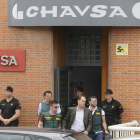 La Guardia Civil conduce a un detenido al coche policial.
