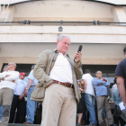 El anterior alcalde socialista de Fabero, Demetrio Alonso, consulta el móvil ante el consistorio.