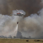 Un helicóptero descarga agua en la zona en llamas. MARCIANO PÉREZ
