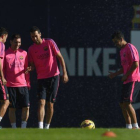 Xavi Hernández, Leo Messi y Sergio Busquets, en el entrenamiento del Barça, este viernes.