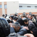 Decenas de personas siguen al coche fúnebre de uno de los fallecidos en Toulouse.