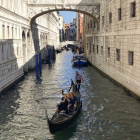 Una pareja disfruta de un viaje en góndola por un canal de Venecia. ANTONELLO NUSCA