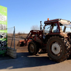 Un tractor permanece apostado junto al cartel de precios de la gasolinera de una cooperativa.
