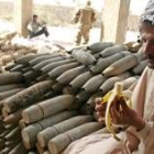 Un empleado iraquí se come un plátano en una comisaría de Bagdad en la que se recogen armas