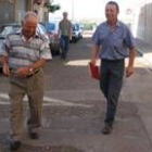 Máximo Panchón, a la derecha, acompañado de un vecino se dispone a entrar en el Obispado de Astorga