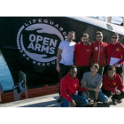 La tripulación integrada por miembros de la oenegé Open Arms junto al barco 'Golfo Azzurro' en el Port Vell de Barcelona.