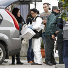 Agentes judiciales y de la Guardia Civil salen de una de las viviendas, en el municipio lucense de Cervo, donde encontraron dos cadáveres.