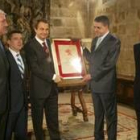 Zapatero y el presidente de Baloncesto León, Manzano, sujetan el pergamino de socio de honor
