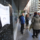 Voluntarios junto a un cartel con la foto de la anciana. L. DE LA MATA