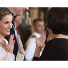 Doña Letizia habla en lengua de signos con una invitada durante la recepción a los representantes instucionales en el Palacio Real con motivo de la proclamación del rey
