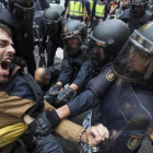 La policia nacional intenta desalojar a las personas concentradas en las puertas del colegio electoral Ramon Llull de Barcelona el 1-O.