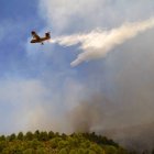 Un avión "Canadair" lanza agua sobre el incendio forestal