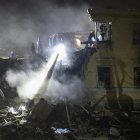 Rescatistas ucranianos trabajan en el lugar donde un cohete impactó esta noche contra un edificio residencial en Kiev. EFE/EPA/SERGEY SHESTAK