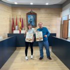 Laura Gallego y Javier Carrera, con el cartel.