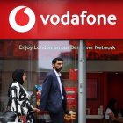 Una pareja ante una tienda de Vodafone.