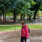 Una señora observa el cierre de parte de las zonas verdes por resiembra.