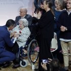El presidente del Gobierno, Pedro Sánchez, saluda a María Luisa Ramos Barril, la única homenajeada que aún vive, durante el acto de homenaje a las víctimas y familiares del golpe militar, la Guerra Civil y el franquismo, con motivo del día en recuerdo a este colectivo fijado en la Ley de Memoria Democrática, que este año tiene lugar a pocos días del 50 aniversario de la muerte de Francisco Franco, este viernes en el Auditorio Nacional de Madrid.
