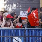 Una simpatizante sujeta un cartel en apoyo al presidente del Gobierno frente sede del PSOE.