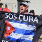 Una persona sostiene una bandera de Cuba durante una manifestación en apoyo al presidente de Estados Unidos, Donald Trump, este domingo en Houston, Texas (Estados Unidos).