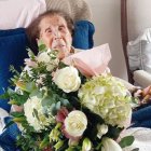 Isaura, ayer en su casa con el ramo de flores regalo de sus sobrinos.  Sus imprescindibles en la mesa.