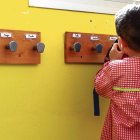 Un alumno cuelga su mochila en el perchero.