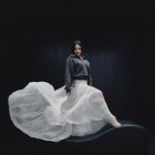 Fotografía cedida por New Balance de la cantante Rosalía en una nueva campaña de la firma norteamericana, posando con una falda blanca de gasa transparente y una sudadera negra. EFE ***SOLO USO EDITORIAL***