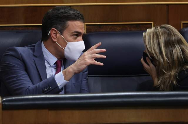 Pedro Sánchez conversa con la vicepresidenta segunda, Yolanda Díaz, ayer, durante el Pleno del Congreso. RODRIGO JIMÉNEZ