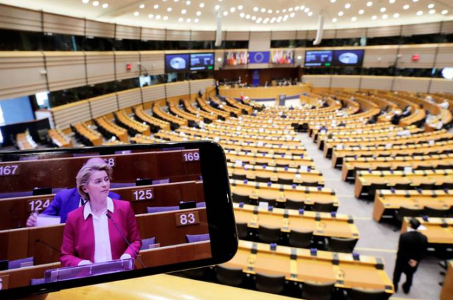 La presidenta de la Comisión Europea es vista en una pantalla de móvil durante una sesión plenaria del Parlamento Europeo. OLIVIER HOSLET