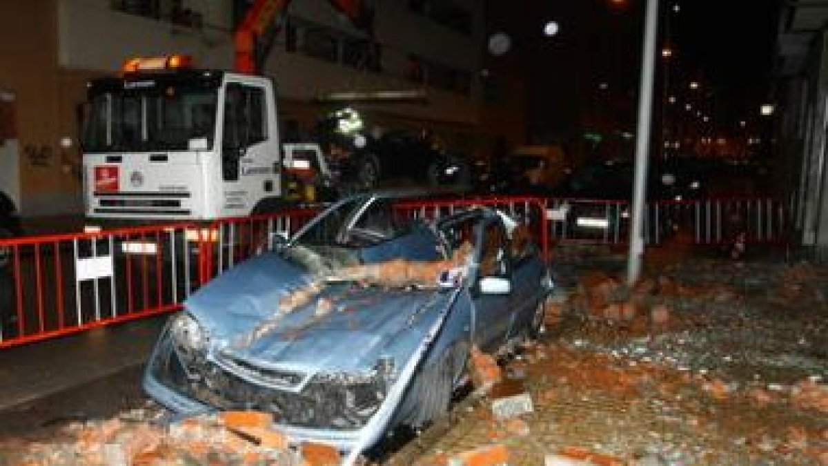 Uno de los coches aplastados por los ladrillos de una fachada en Reyes Católicos.